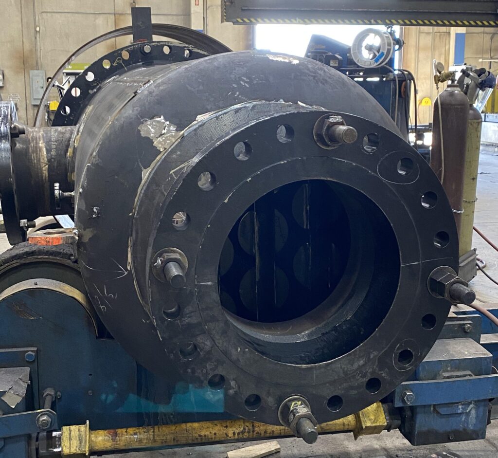 Close-up of a flanged opening on a carbon steel pressure vessel during fabrication.