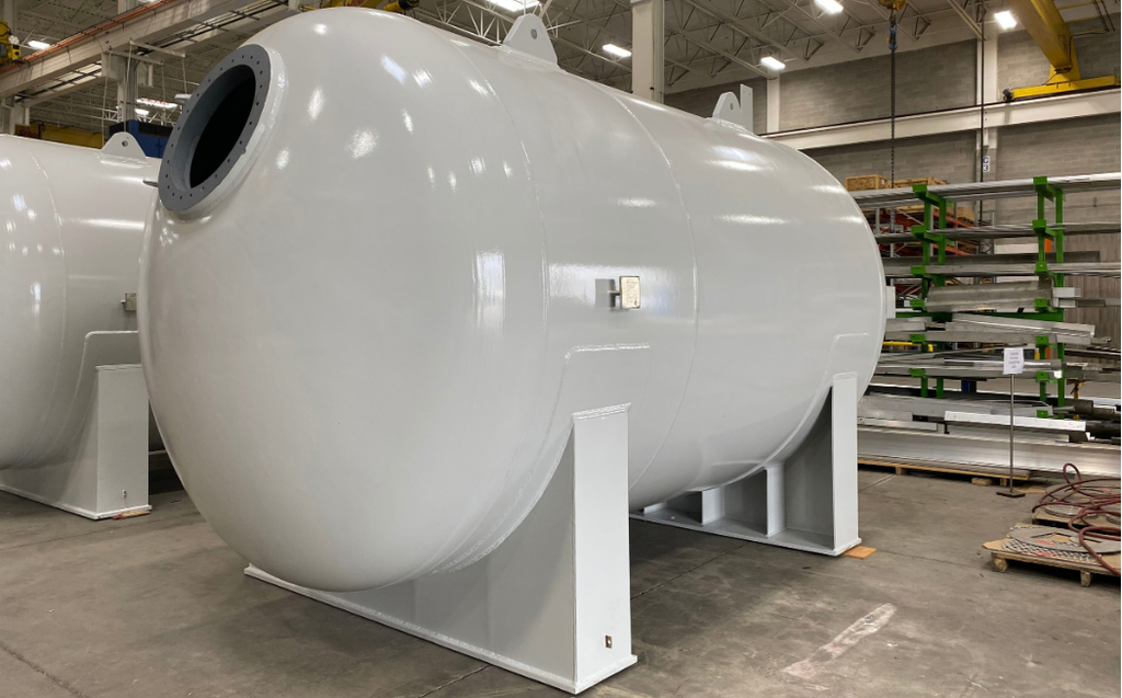 921 water treatment White horizontal water treatment vessel with saddle supports in the Alps Welding shop