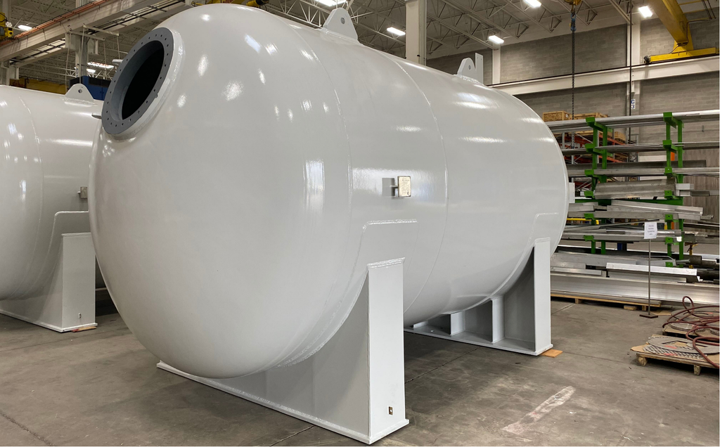 White-coated carbon steel water treatment vessel on saddle supports at Alps Welding.