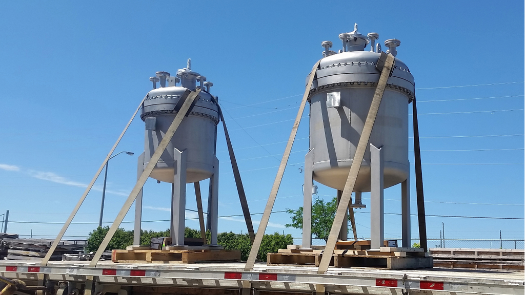 vessel water treatment Two vertical water treatment vessels secured on a flatbed trailer for shipment